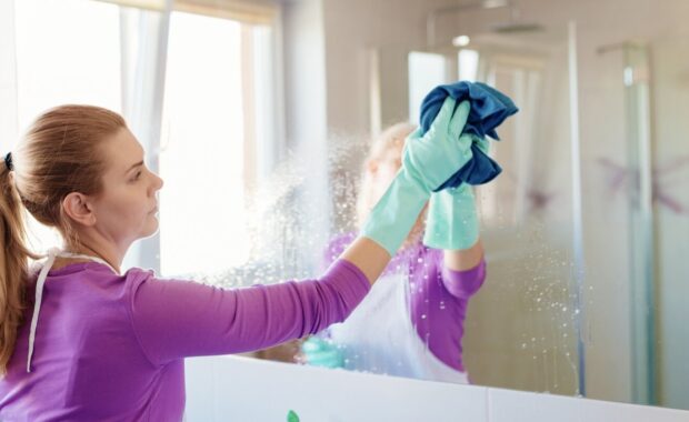 woman cleaning mirror