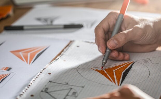 graphic designer drawing sketches logo design