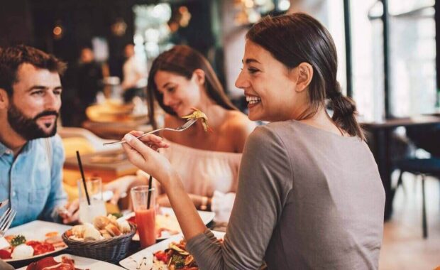 friends sitting in restaurant with custom wall covering