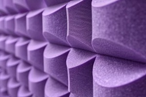 zoomed-in detail of interlocking lilac acoustic wall art foam pieces on a studio wall