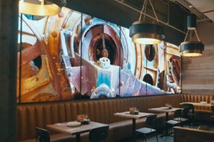 backlit acrylic in a restaurant behind booths