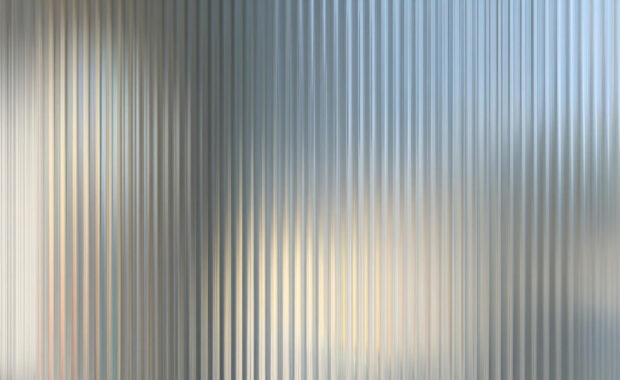 backdrop of textured glass pane with wavy, rippled surface creating distortion