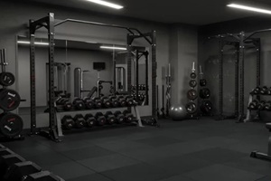 barbell rests on gym equipment in the empty indoor fitness room