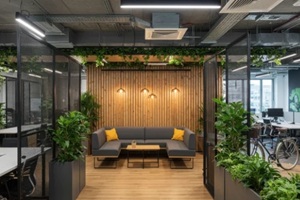 biophilic workspace with plants, wood accents, and comfortable lounge area